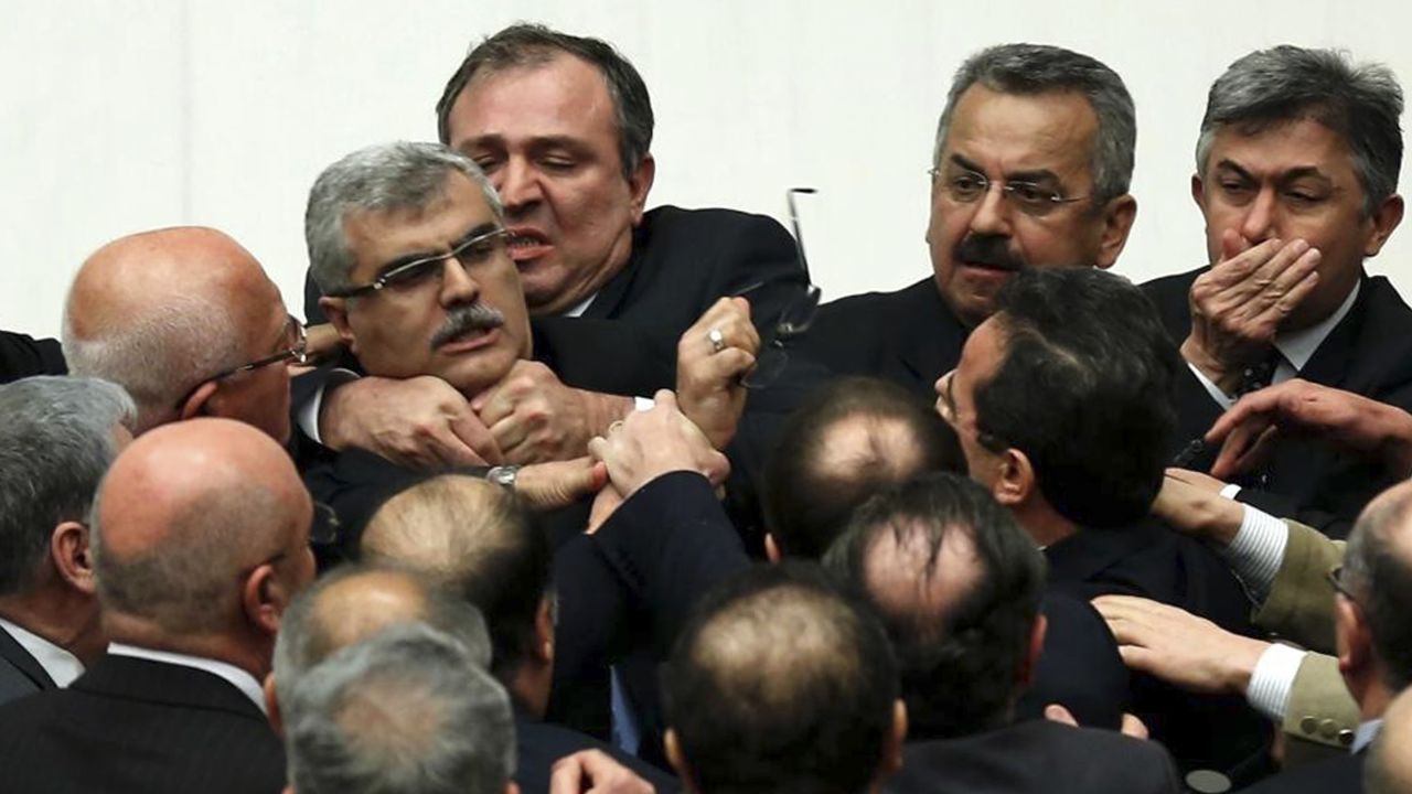 Turkish legislators from Prime Minister Recep Tayyip Erdogan's ruling party and the main opposition Republican People's Party brawl during a tense all-night debate over a controversial law on changes to a council that appoints and overseas judges and prosecutors, in Ankara, early Saturday, Feb. 15, 2014. One legislator suffered a broken finger while another suffered a nose-bleed. Opposition parties say the bill would give the government wider controls over the council. (AP Photo)
