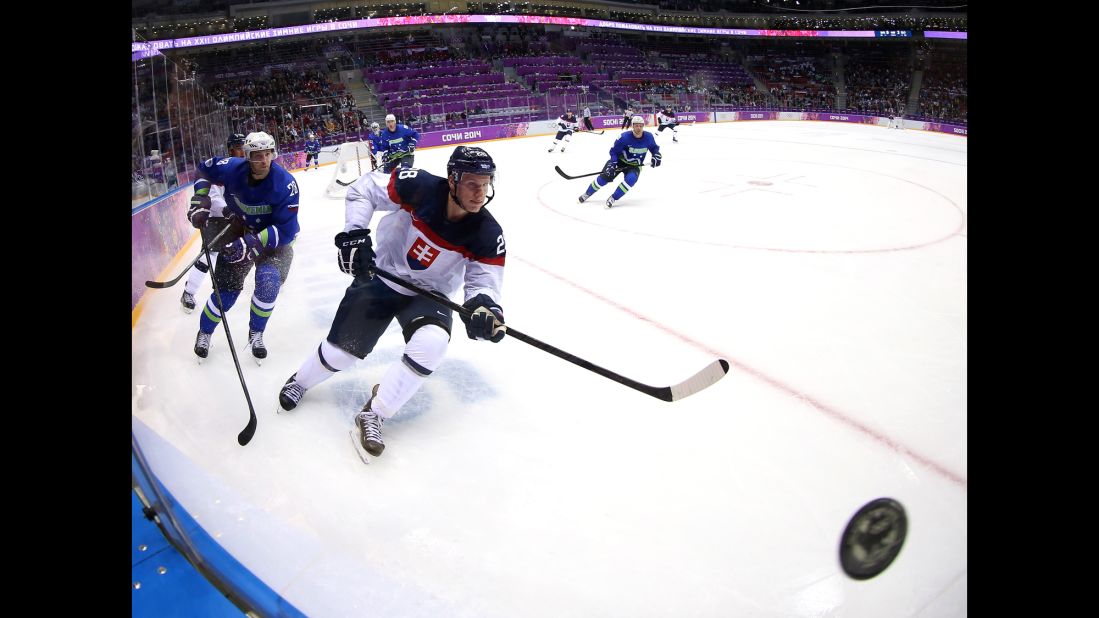 Richard Panik of Slovakia and Ales Kranjc of Slovenia chase after a puck during their game February 15.