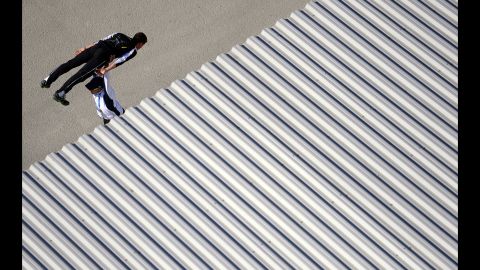 A ski jumper warms up with his coach prior to training on February 15.