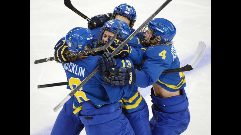 The women's hockey team from Sweden celebrates a goal against Finland on February 15.