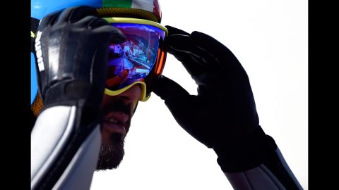 Giuseppe Michielli of Italy adjusts his goggles February 15 during training for the large hill Nordic combined event.