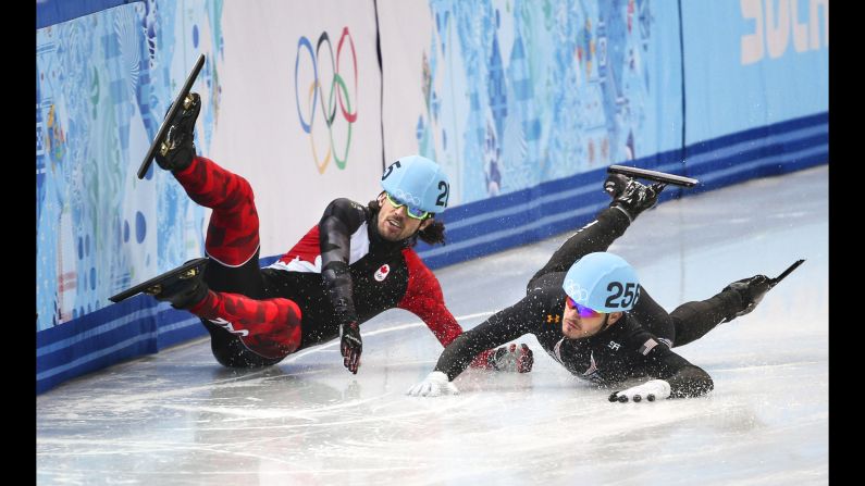 Canada's Charles Hamelin crashes, taking out American Eduardo Alvarez during the quarterfinals of the 1,000-meter short track speedskating event.