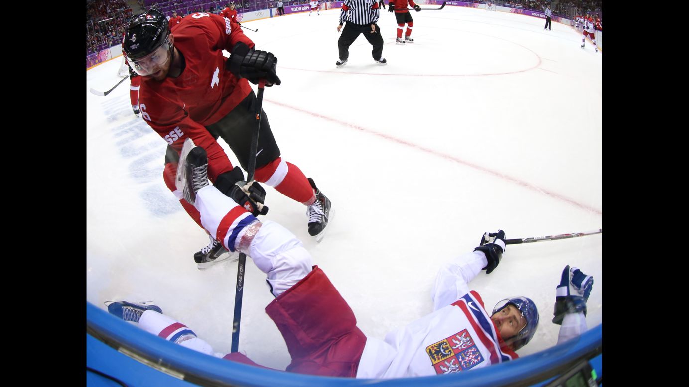 Petr Nedved of the Czech Republic falls to the ice after being checked by Switzerland's Yannick Weber during the men's hockey game on February 15.