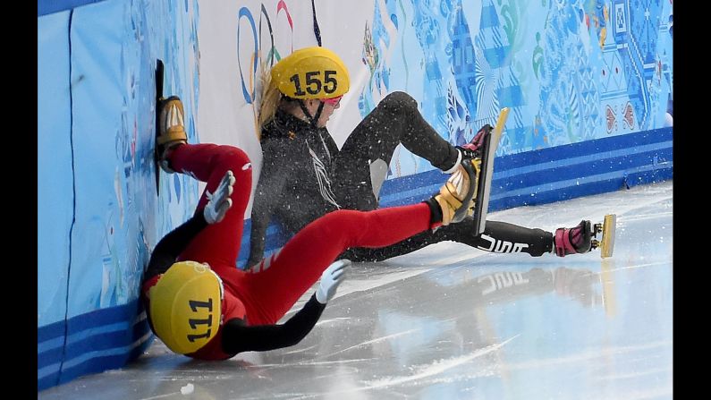 China's Alang Ki, in red, and the USA's Emily Scott crash into the wall after colliding during the finals of the women's 1,500-meter short track speedskating race on February 15.