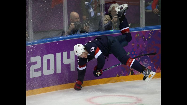 U.S. forward T.J. Oshie goes flying into the boards during the first period of the men's hockey game against Russia on February 15.