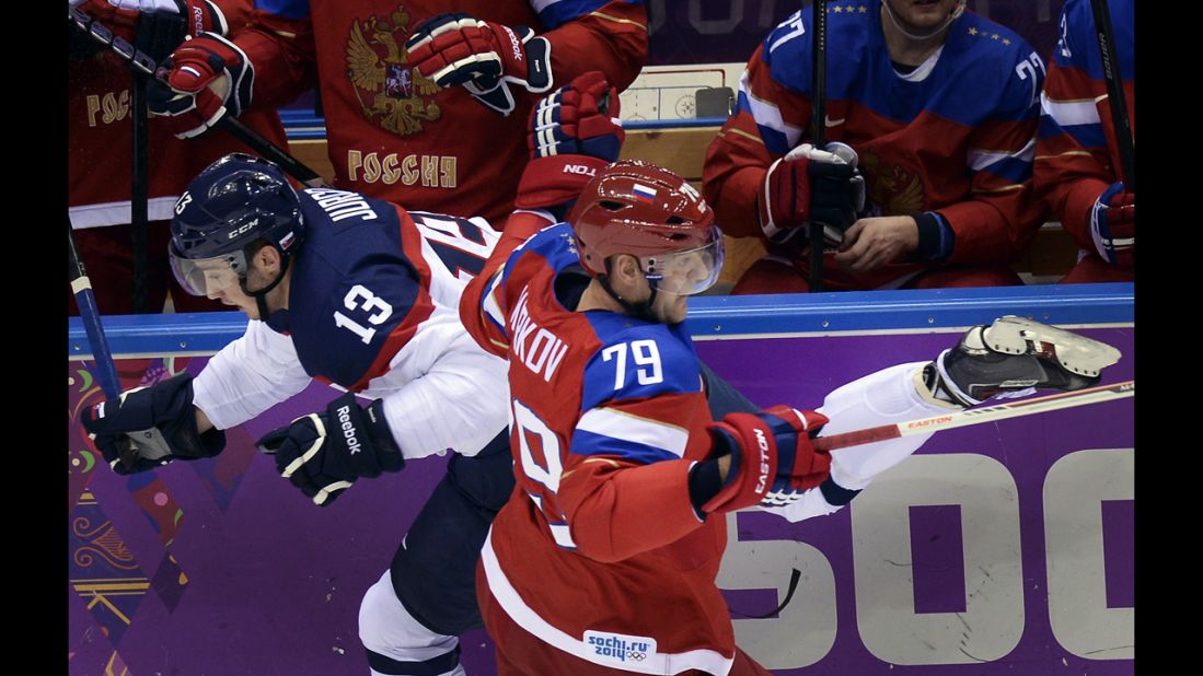 Russia's Andrei Markov challenges Slovakia's Tomas Jurco during the men's ice hockey game on February 16.