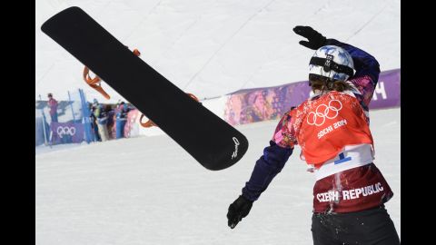 Czech athlete Eva Samkova throws her snowboard as she celebrates winning the final of the women's snowboard cross on February 16.