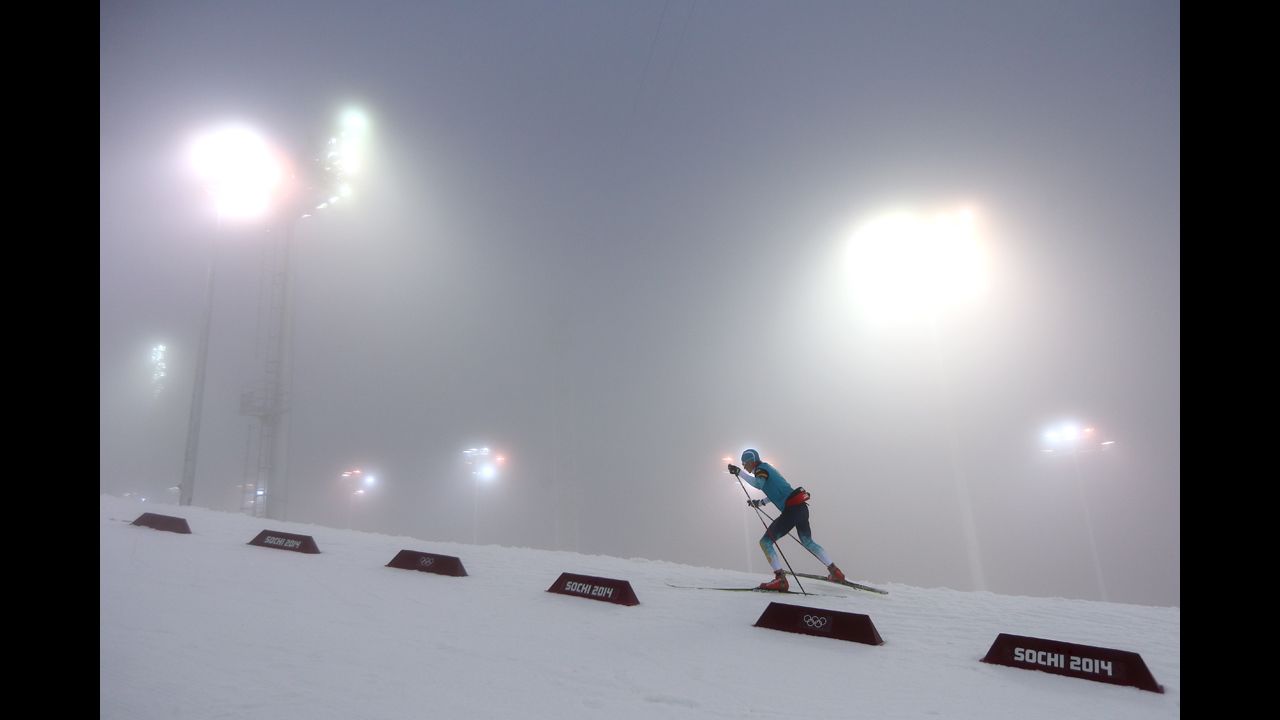 A biathlete warms up for the men's 15-kilometer mass start event on February 16.