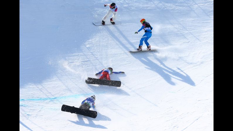 Snowboarders fall during the quarterfinals of women's snowboard cross on Sunday, February 16. 