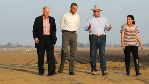 President Barack Obama (2nd-L) walks with California Governor Jerry Brown (L), Joe and Maria Del Bosque (R) of Empresas Del Bosque farm, addressing California's drought situation Friday, Feburary 14, 2014 in Los Banos, CA.