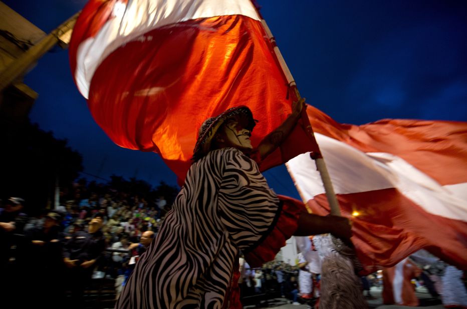 A reveler carrying a giant flag performs in Montevideo on February 14. 