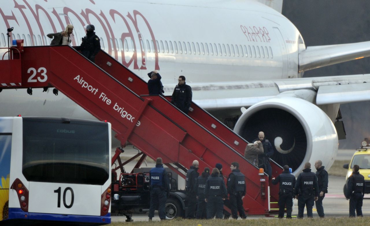 Police evacuate passengers on February 17, 2014 from the Ethiopian Airlines flight en route to Rome, which was hijacked and forced to land in Geneva, where the hijacker was arrested, police said. 