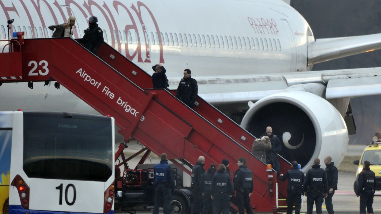 Police evacuate passengers on February 17, 2014 from the Ethiopian Airlines flight en route to Rome, which was on hijacked and forced to land in Geneva, where the hijacker has been arrested, police said.