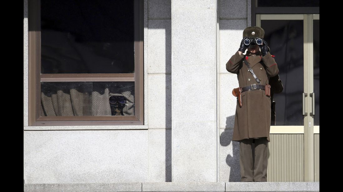 A North Korean soldier uses binoculars on Thursday, February 6, to look at South Korea from the border village of Panmunjom, which has separated the two Koreas since the Korean War.