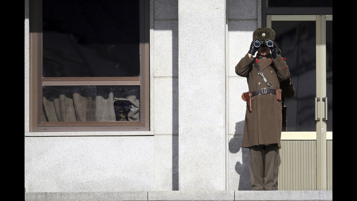 A North Korean soldier uses binoculars on Thursday, February 6, to look at South Korea from the border village of Panmunjom, which has separated the two Koreas since the Korean War. 