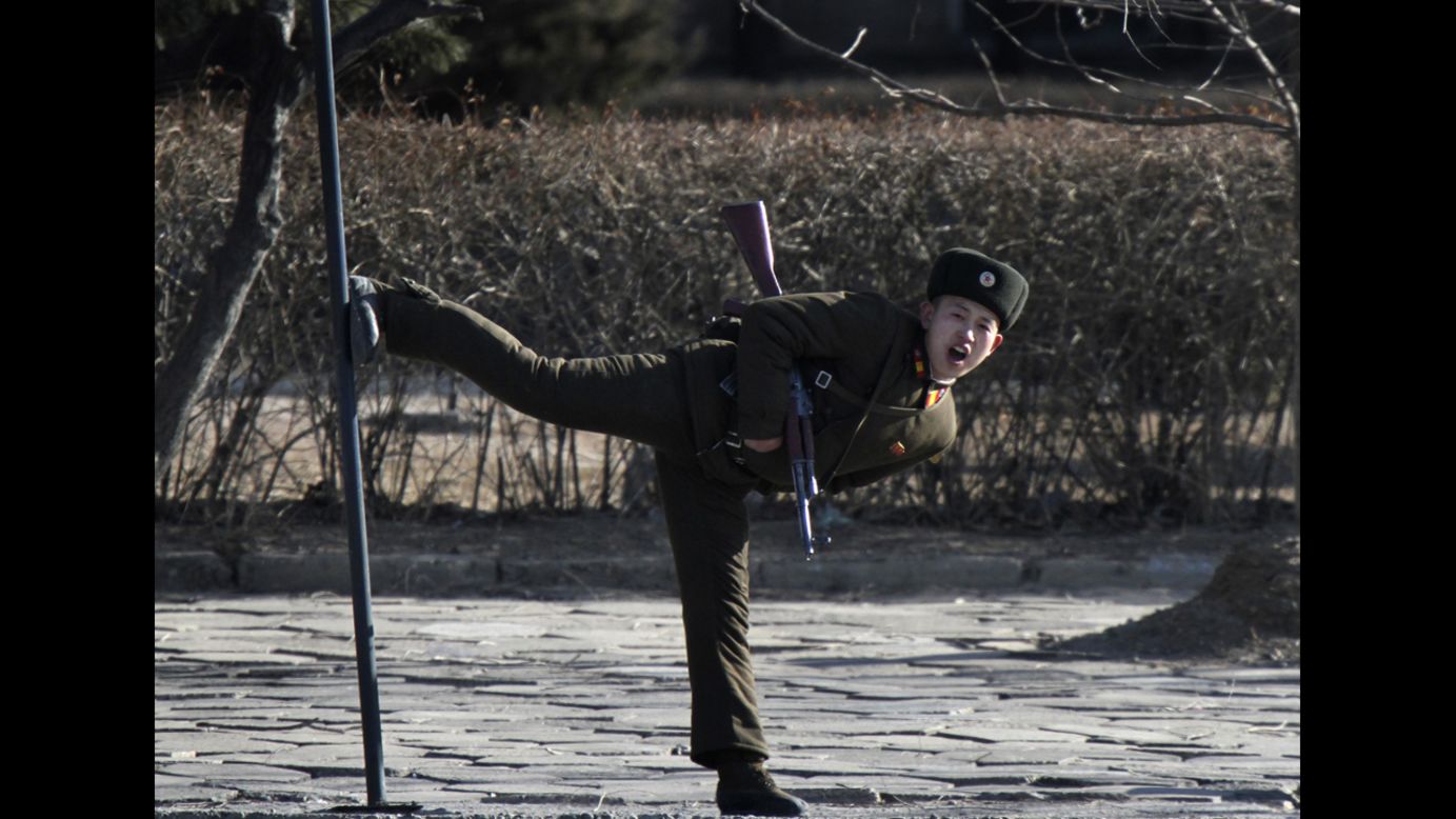 A North Korean soldier kicks a pole along the banks of the Yalu River on Tuesday, February 4.
