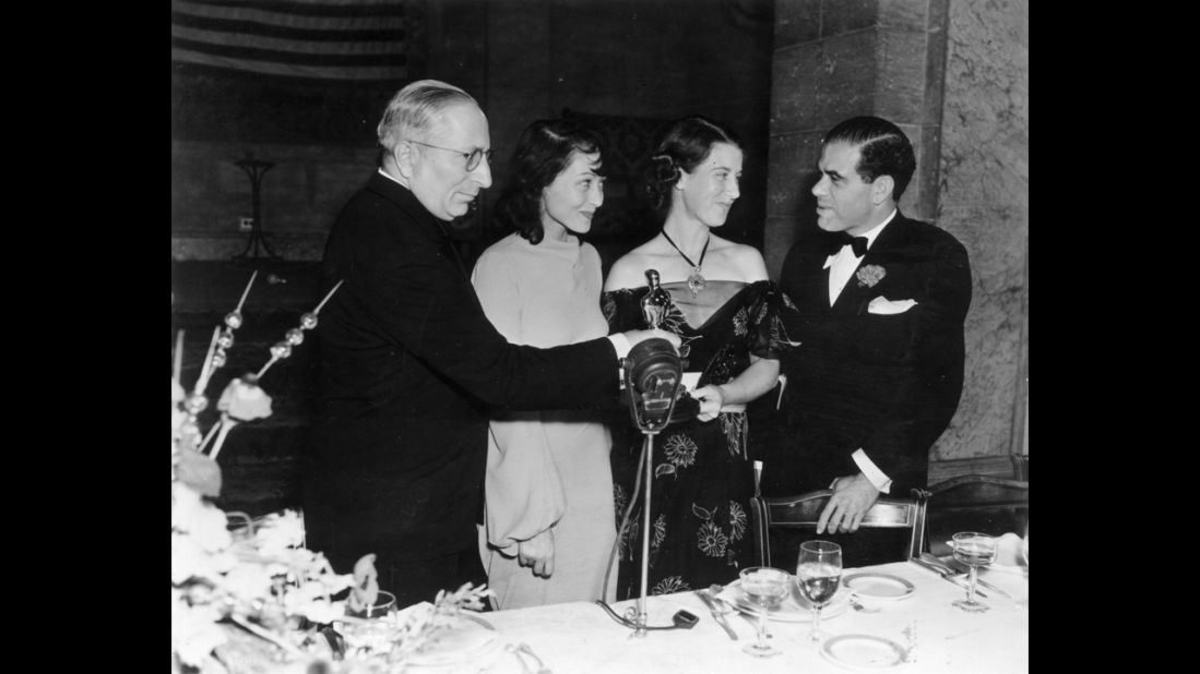 <strong>Luise Rainer (1937):</strong> Luise Rainer, second from left, is seen at the 1937 ceremony with, from left, Louis B. Mayer, Louise Tracy and Frank Capra. Rainer won for "The Great Ziegfeld."