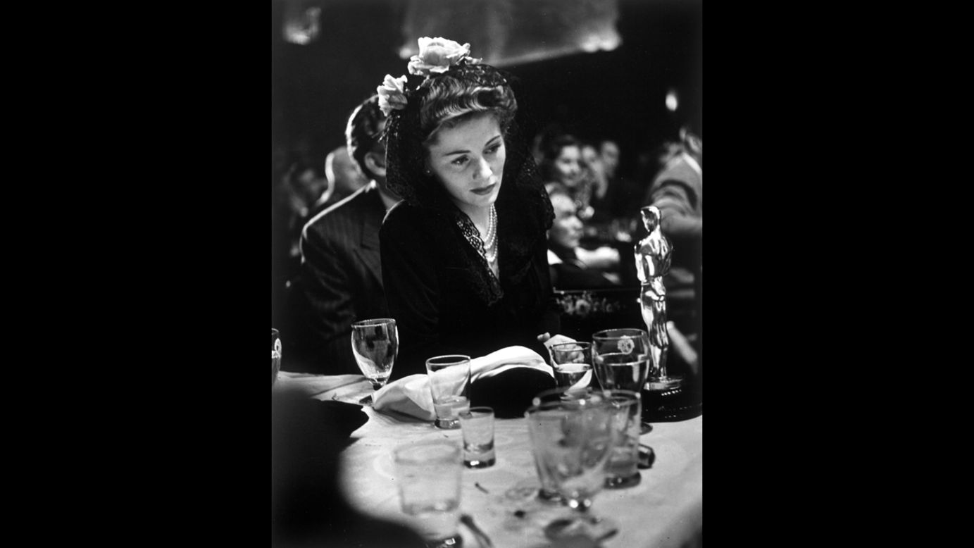 <strong>Joan Fontaine (1942):</strong> Joan Fontaine looks at the best actress Oscar she won for her role in the film "Suspicion." 
