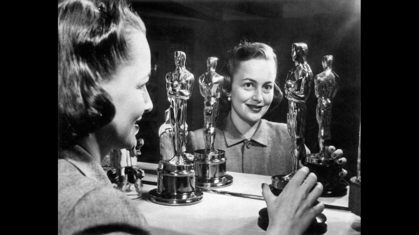 <strong>Olivia de Havilland (1950):</strong> Olivia de Havilland looks at her two best actress Oscars. She won her second in 1950 for her role in "The Heiress."
