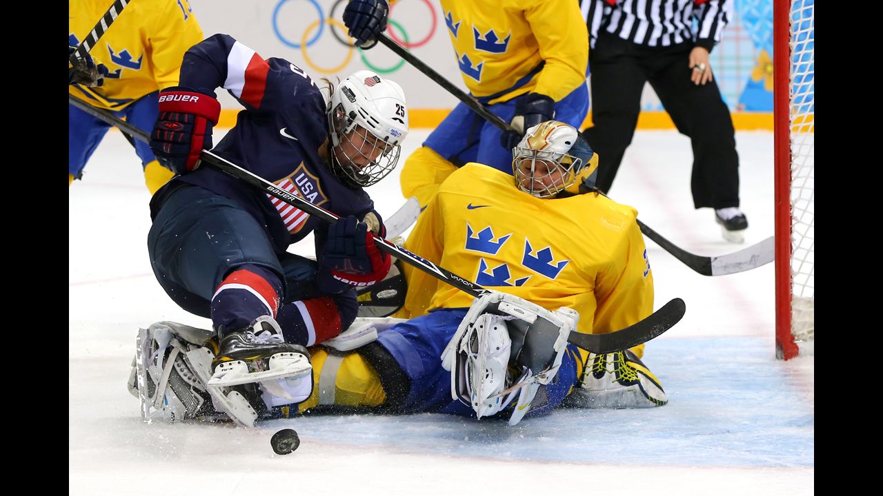 Women's hockey player Alex Carpenter of the United States tries to shoot against Valentina Lizana Wallner of Sweden during their semifinal game February 17.