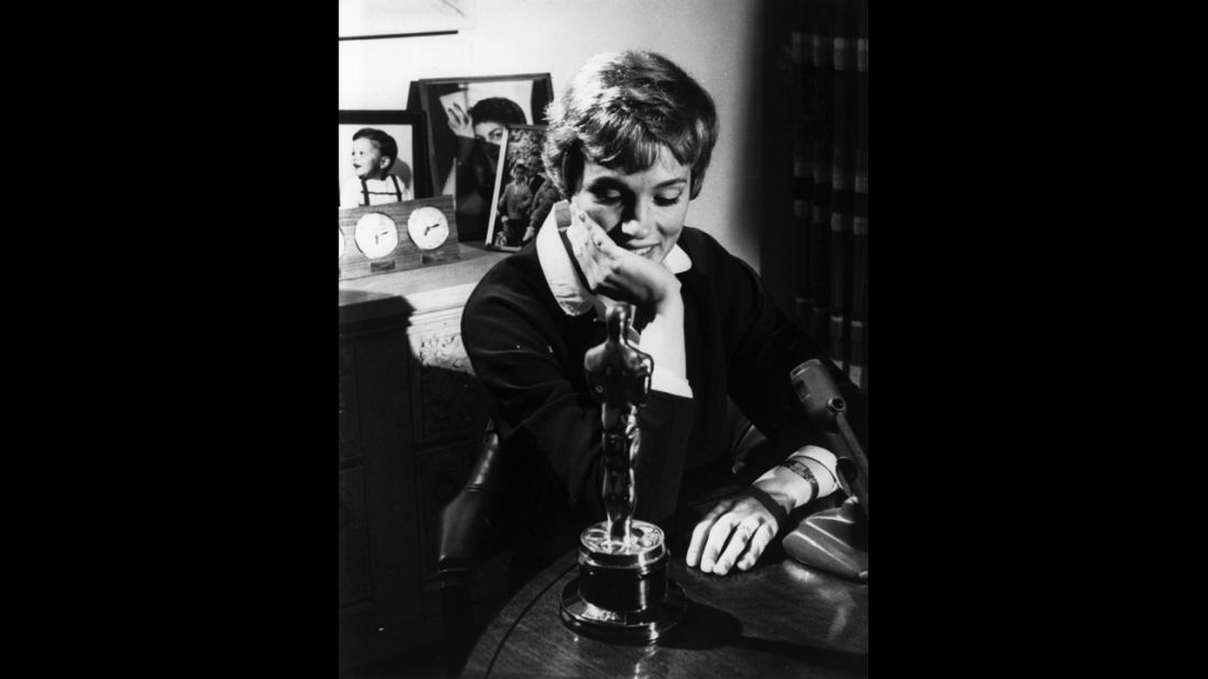 <strong>Julie Andrews (1965): </strong>Julie Andrews looks at the Academy Award she won for "Mary Poppins'" in 1965. The role was her film debut.  