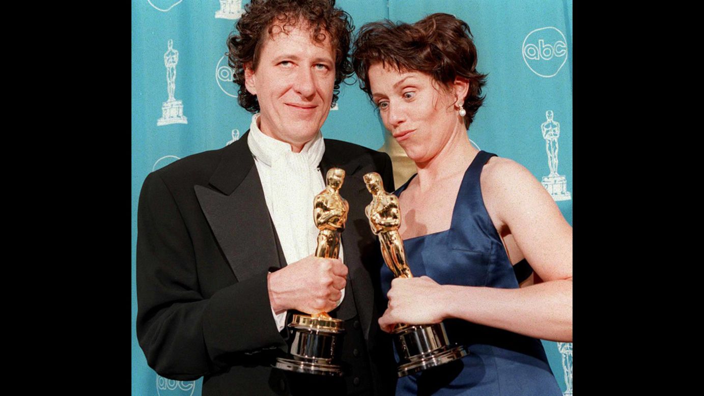 <strong>Frances McDormand (1997):</strong> Frances McDormand, who won best actress for her role in "Fargo," poses with Geoffrey Rush, who won best actor that year. 