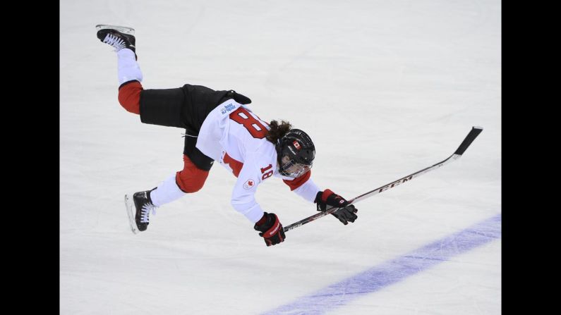 Canadian hockey player Catherine Ward falls after she was hit in the Olympic semifinal against Switzerland on Monday, February 17. 