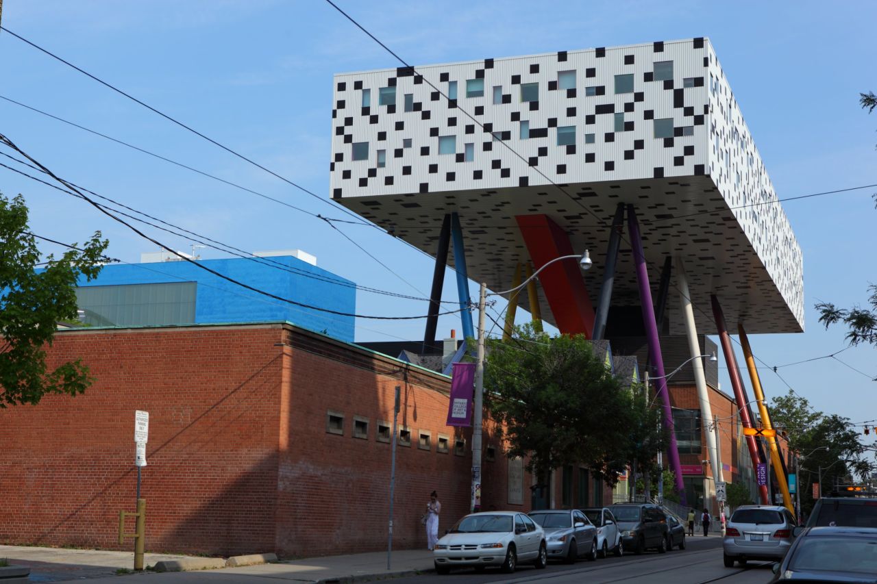 At Toronto's OCAD University, the Sharp Centre for Design is perched 26 meters above the ground on 12 stilts representing giant pencils. Five legs out of the six multi-colored pairs are painted black to give an illusion of slenderness, especially at night when the black legs seem to disappear. <strong>Architects:</strong> Alsop Architects, Robbie/Young + Wright Architects.