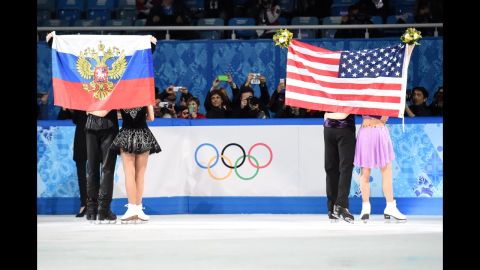 Russians Nikita Katsalapov and Elena Ilinykh, left, and Americans Meryl Davis and Charlie White celebrate during the flower ceremony for the Olympic ice dancing competition Monday, February 17. The Americans won gold and the Russians won bronze. 