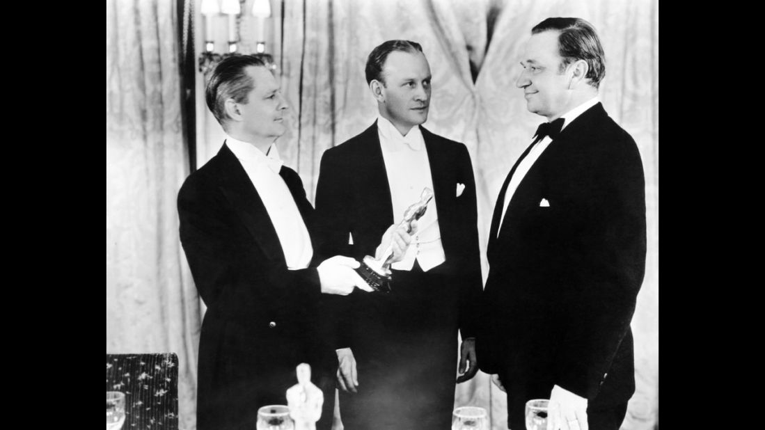 <strong>Wallace Beery (1932):</strong> The previous year's Oscar winner Lionel Barrymore, left, presents Wallace Beery, right, with the best actor Oscar for "The Champ." Beery tied that year with Fredric March in "Dr. Jekyll and Mr. Hyde." 