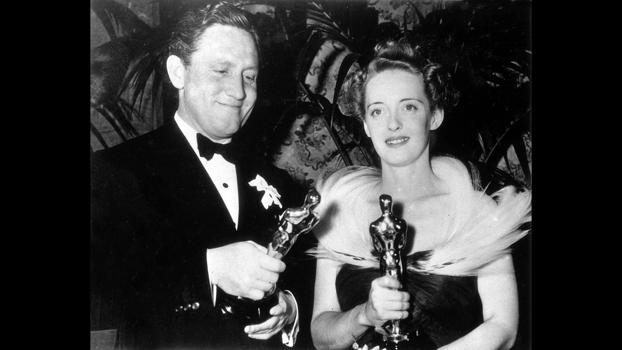 <strong>Spencer Tracy (1939):</strong> Spencer Tracy takes home his second best actor Oscar for "Boys Town." He appears here with Bette Davis, best actress for "Jezebel," at the ceremony held in 1939.