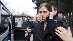 Nadezhda Tolokonnikova from the band Pussy Riot  is escorted to a police car after being detained in the Adler district of Sochi, on February 18, 2014.