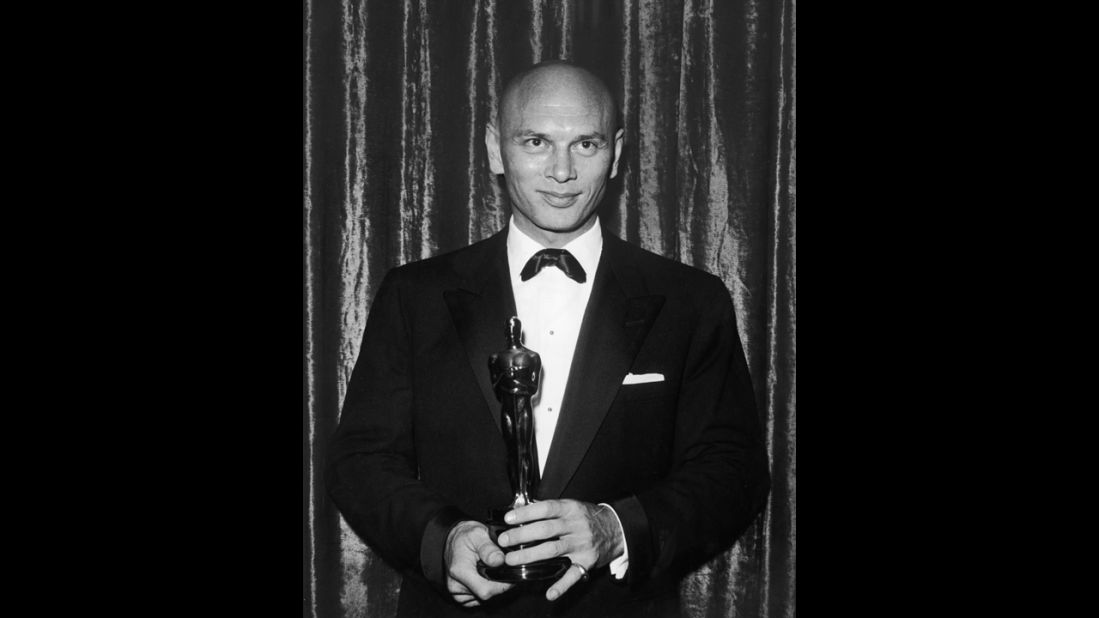 <strong>Yul Brynner (1957):</strong> Yul Brynner repeated his stage success as the King of Siam, winning the best actor Oscar for "The King and I." He's pictured at the 1957 ceremony. 