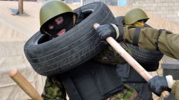 Maidan self-defence activists fight during a drill in a camp of the Ukrainian anti-government opposition on Independence Square in Kiev on February 17, 2014.
