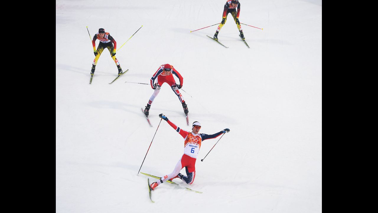 Joergen Graabak of Norway celebrates as he crosses the line to win the gold medal in the large hill Nordic combined event February 18.