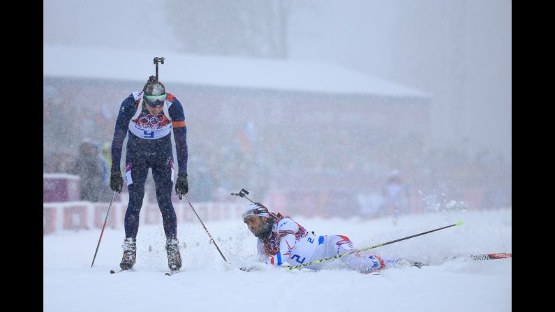 Emil Hegle Svendsen of Norway, left, crosses the line to win gold ahead of Martin Fourcade of France in the men's 15-kilometer mass start biathlon on February 18.