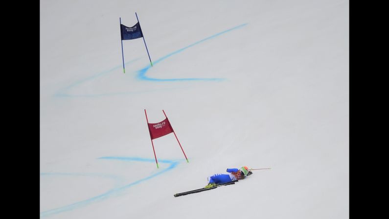 Italy's Denise Karbon lies on the slope after falling during the women's giant slalom on February 18.