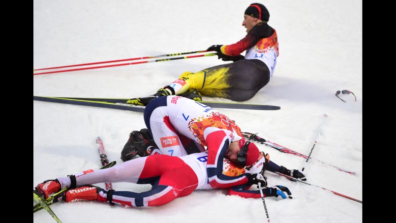 Norway's Joergen Graabak, bottom, celebrates with Norway's Magnus Hovdal Moan after the large hill Nordic combined event on February 18. Graabak won gold and Moan won silver.