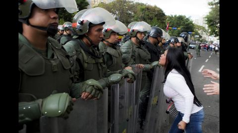 A young woman argues with members of the Venezuelan National Guard during an anti-government protest in Caracas on Monday, February 17.