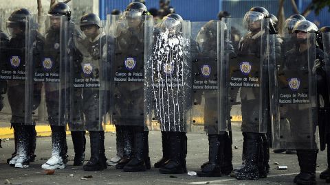 Riot police stand during clashes in Caracas on February 15.