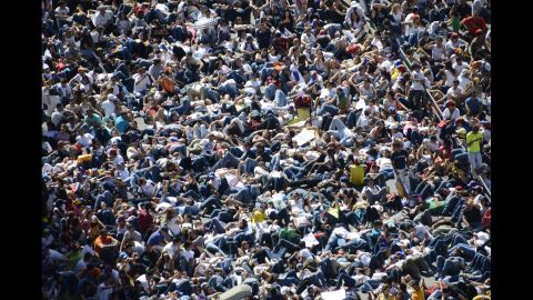 Thousands of students lie on the ground during a protest in front of the Venezuelan Judiciary building in Caracas on February 15.