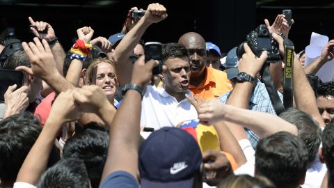 Opposition leader Leopoldo Lopez greets supporters during a demonstration in Caracas on Wednesday, February 12. Lopez was charged with murder, terrorism and arson in connection with the protests, according to his party, Popular Will. Lopez denies the accusations, the party said in a statement.