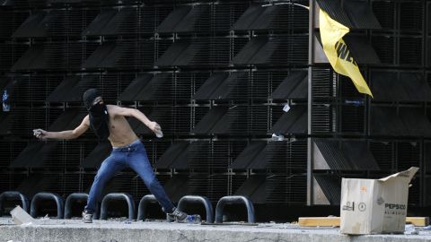 A protester throws a stone in Caracas on February 12.