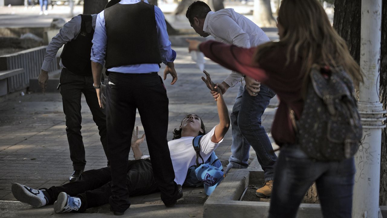 Police detain a student during clashes in Caracas on February 12.