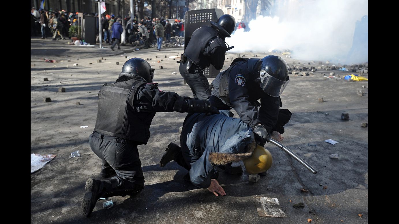 Riot police detain a protester in Kiev on February 18.