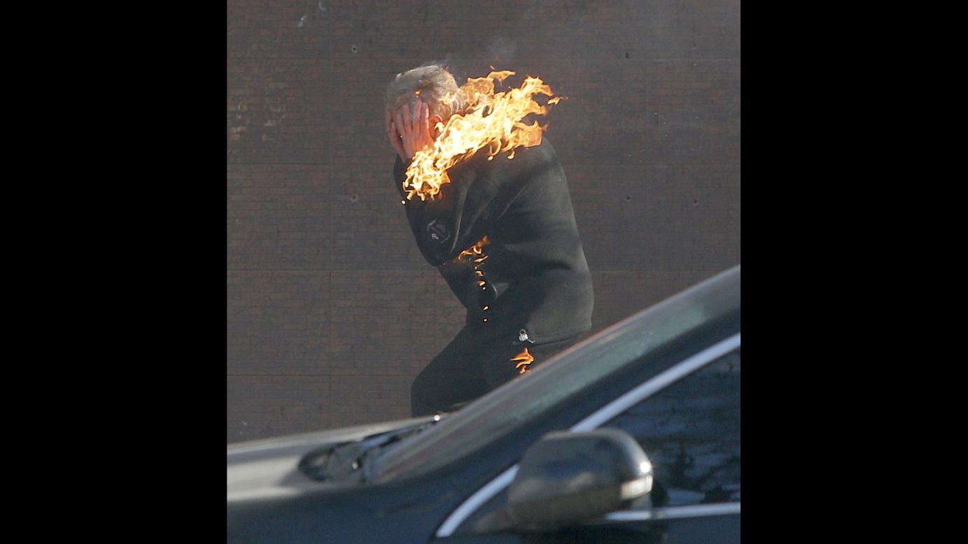 A protester is engulfed in flames while running from the clashes in Kiev on February 18.