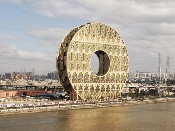 The Guangzhou Circle is not meant to resemble a cable reel, a spool of thread or a wheel. According to Italian architecture firm <a href="index.php?page=&url=http%3A%2F%2Fwww.amprogetti.it%2Findexamp.php" target="_blank" target="_blank">A.M. Progett</a>i, it actually invokes an ancient jade disc, which included a hole at its center. Employees inside the building, which is home to the world's largest stock exchange for plastic, are privy to another spectacular feature. When reflected into the nearby river, the building forms the number 8—a symbol of luck in China.