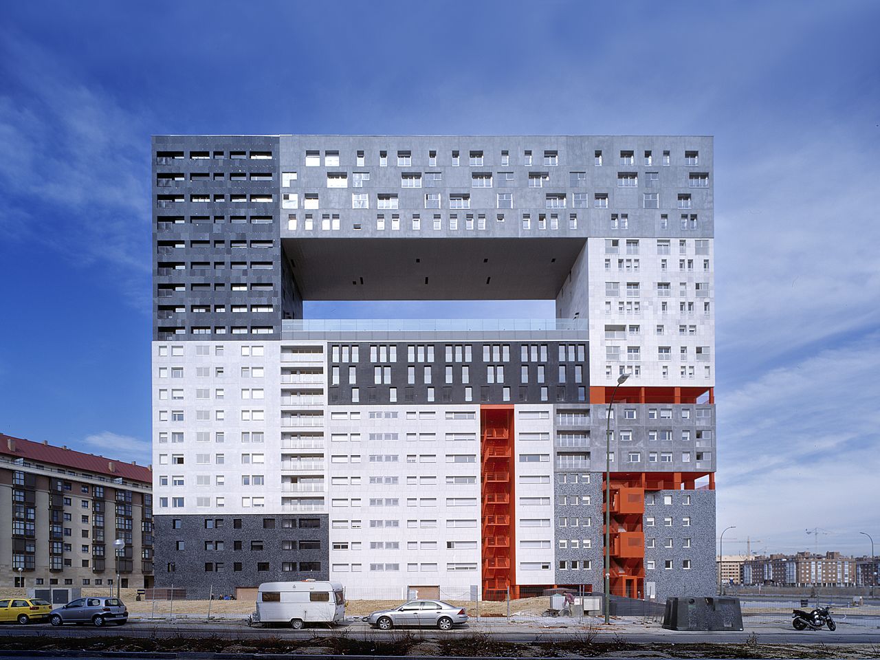Architectural firm MVRDV did not run out of money before completing <a href="http://www.mvrdv.nl/projects/mirador/" target="_blank" target="_blank">The Mirador</a> apartment complex in Madrid. The hole in the middle is actually a semi-public sky plaza which provides an ideal vantage point to enjoy the nearby Guadarrama Mountains. It also includes a community garden, thereby "monumentalizing public life and space."