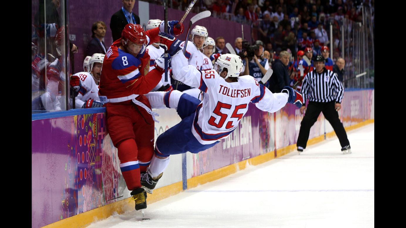 Alexander Ovechkin of Russia checks Ole-Kristian Tollefsen of Norway during the men's hockey game February 18.