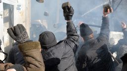 Anti-government protesters throw rocks during clashes with police in front of the Ukrainian Parliment in Kiev on February 18, 2014. At least three anti-government protesters were killed and some 150 others injured, some seriously, today in fresh clashes between police and demonstrators protesting near Ukraine's parliament building in Kiev. Medics at an opposition-run field hospital said that most of the injuries were caused by stun grenades while some of the 30 people in a serious condition had suffered head injuries, and one person had to have a hand amputated. AFP PHOTO / SERGEI SUPINSKYSERGEI SUPINSKY/AFP/Getty Images